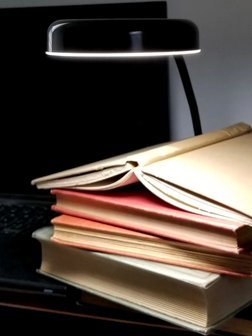 Two stacks of books against blue background